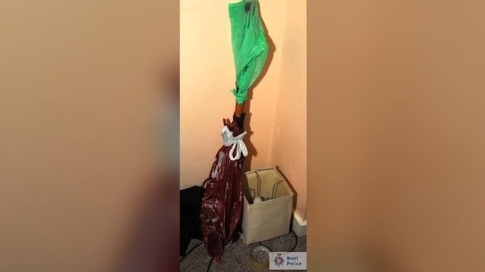 Police evidence image of a long object wrapped in plastic bags