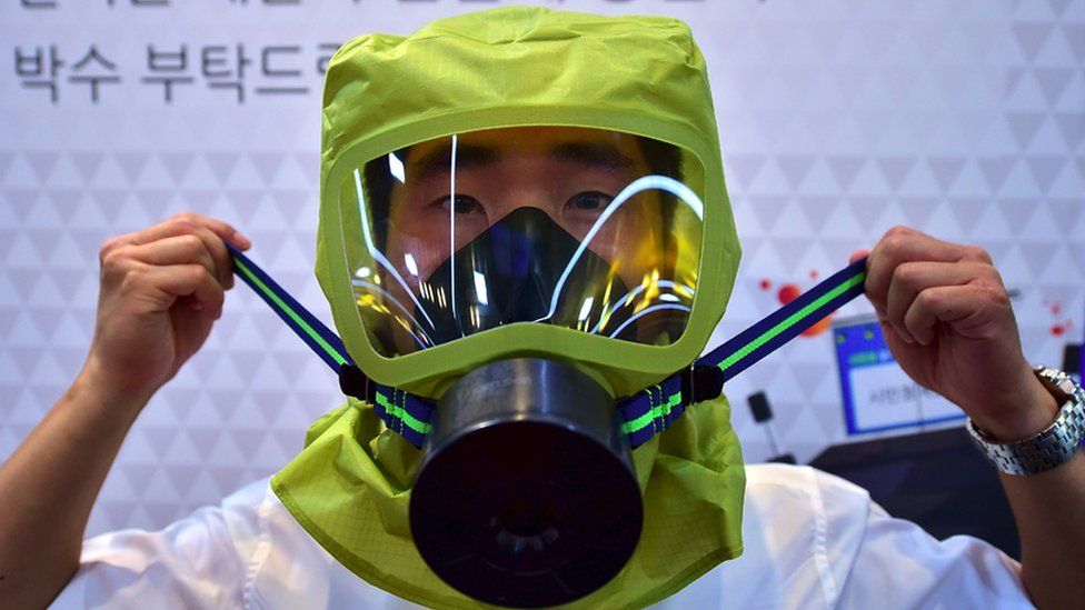 Man in gas mask during civil defence practice in Seoul