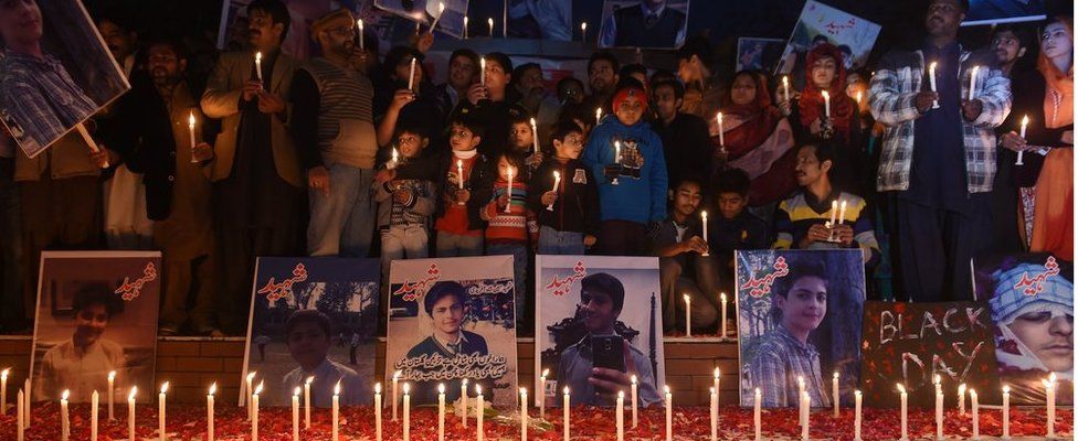 Pakistani political party workers, traders and students light candles during a vigil in Islamabad on 18 December 2014, for the children and teachers killed in the attack
