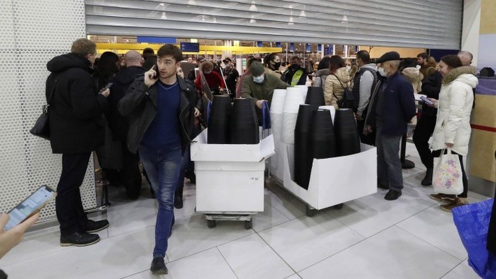 Russian people buy a furniture and household goods in IKEA hypermarket before the store closes in St. Petersburg
