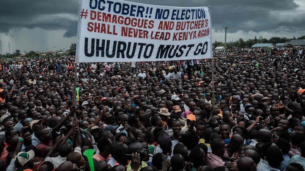 Supporters of Kenya"s opposition National Super Alliance (NASA) coalition hold a banner during a political rally in Kisumu, western Kenya, on October 20, 2017.