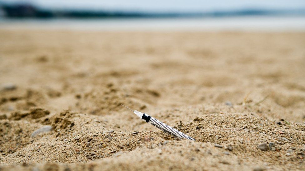 A syringe at a beach