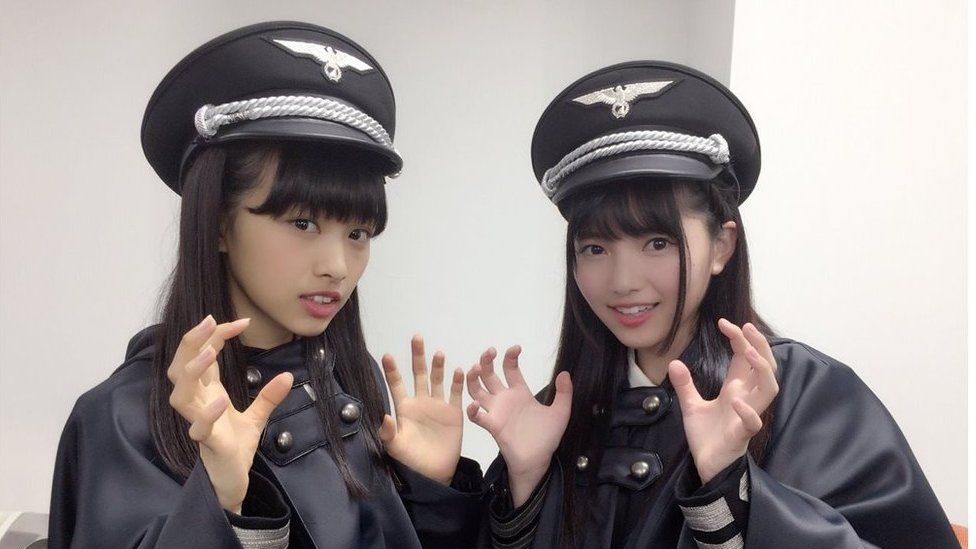Two members of Keyakizaka46, posing in the costumes