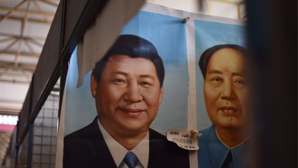 This photo taken on September 19, 2017 shows painted portraits of Chinese President Xi Jinping (L) and late communist leader Mao Zedong at a market in Beijing.