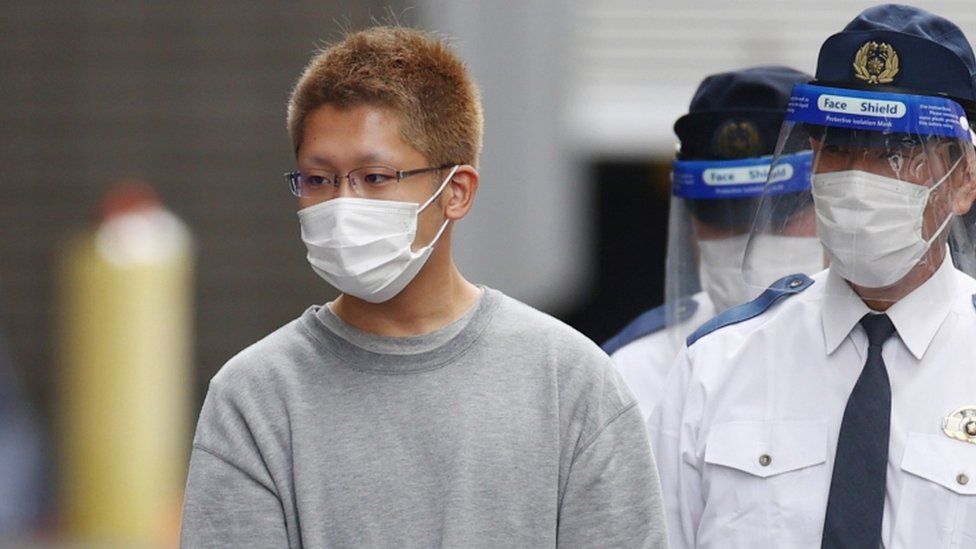 Kyota Hattori (L), a 24-year-old suspect of a knife and arson attack on a Tokyo train, is taken to prosecutors on suspicion of attempted murder, in Tokyo, Japan, 02 November 2021.