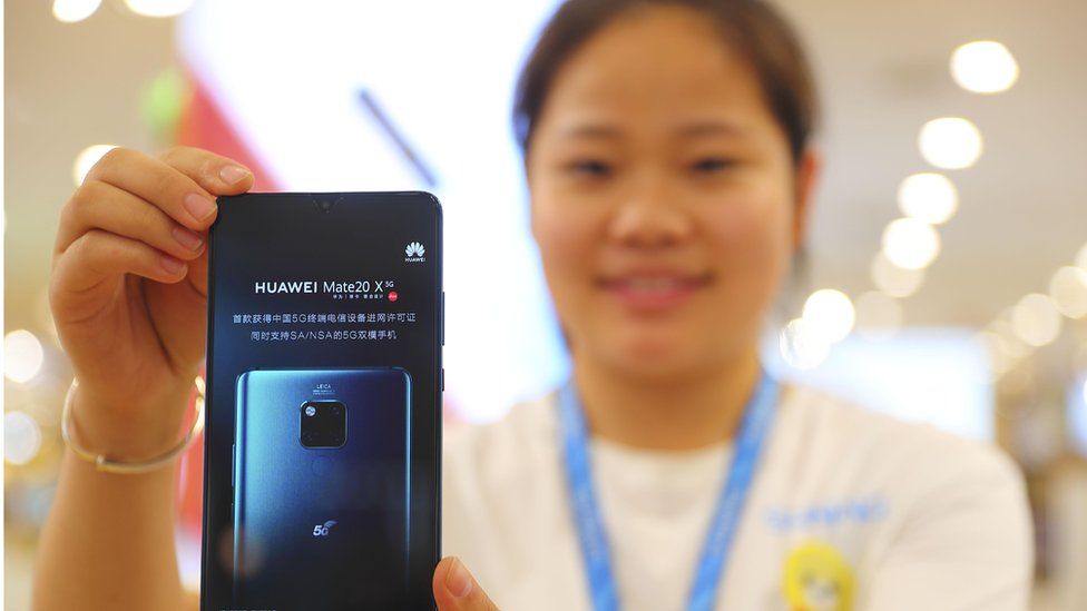 A worker presents a 5G smartphone Mate 20X at a Huawei Store on July 27, 2019 in Taiyuan, Shanxi Province of China.