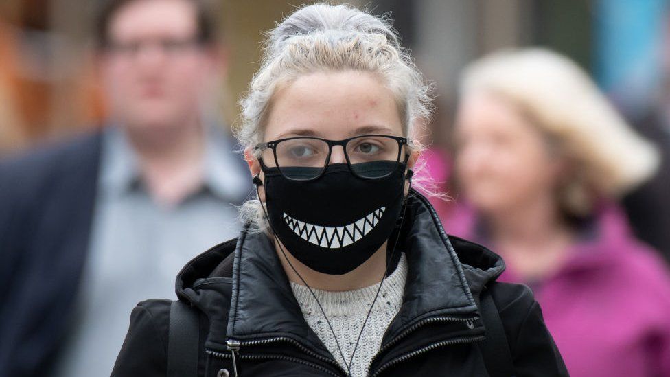 A person wearing a facemask in Cardiff