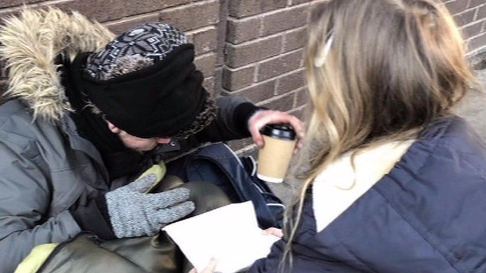 Florence giving a hot drink to a rough sleeper