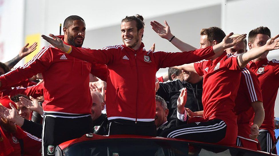 Ashley Williams (Left) with Gareth Bale (Centre) at the Wales team's home coming in Cardiff in July