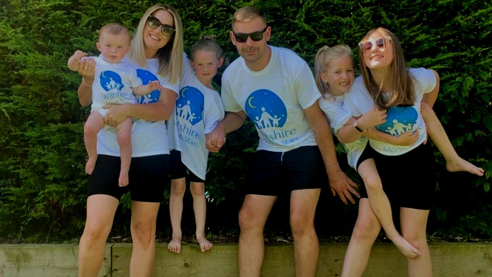 Abby Lever and Jamie Davey with their children whilst in the garden.