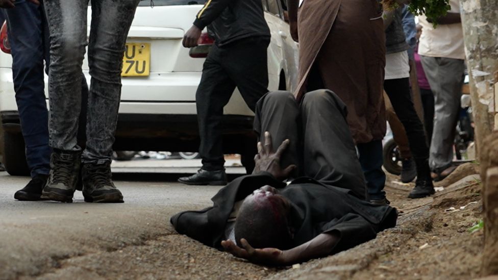 Man lying on the floor by the road