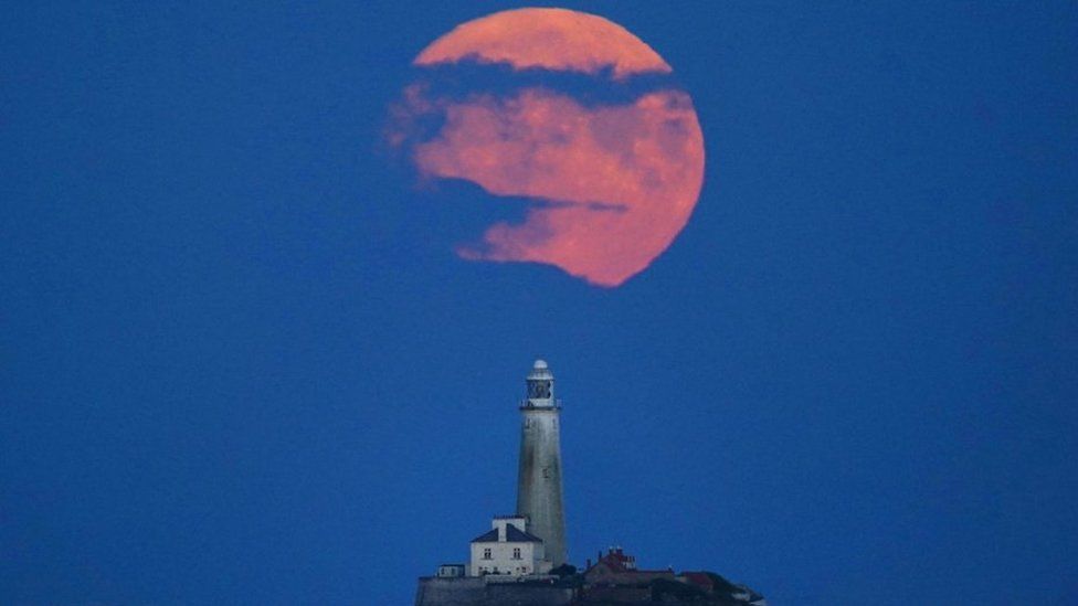 The Full Buck supermoon rises over St Mary's Lighthouse in Whitley Bay on 2 July