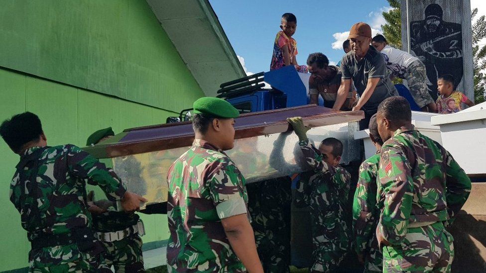 Indonesian soldiers prepare coffins for construction workers, believed to have been shot dead in Papua province on December 4, 2018
