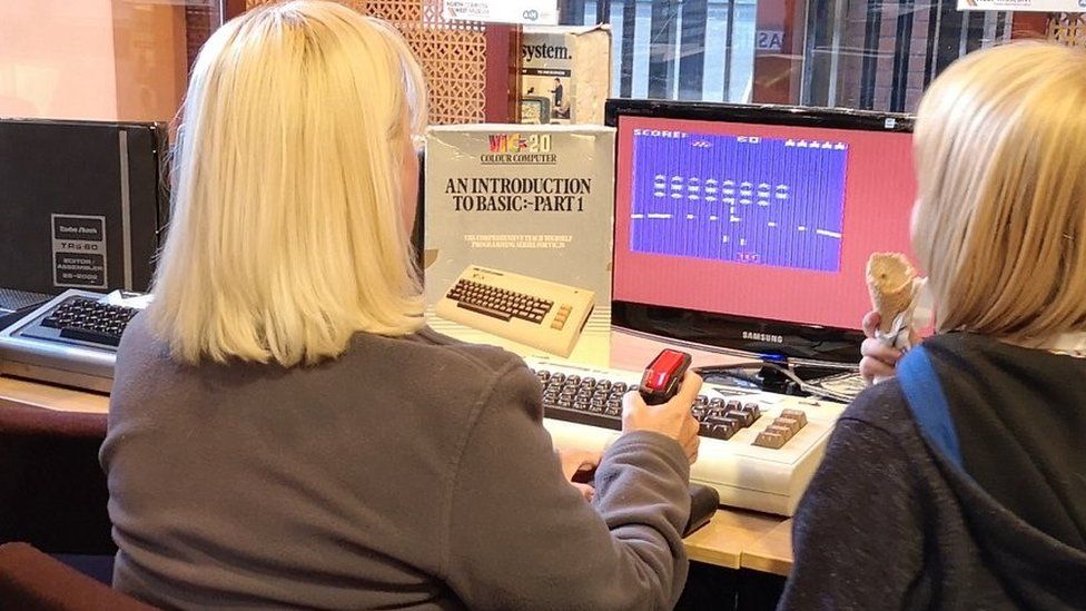 A woman playing a computer game at North West Computer Museum