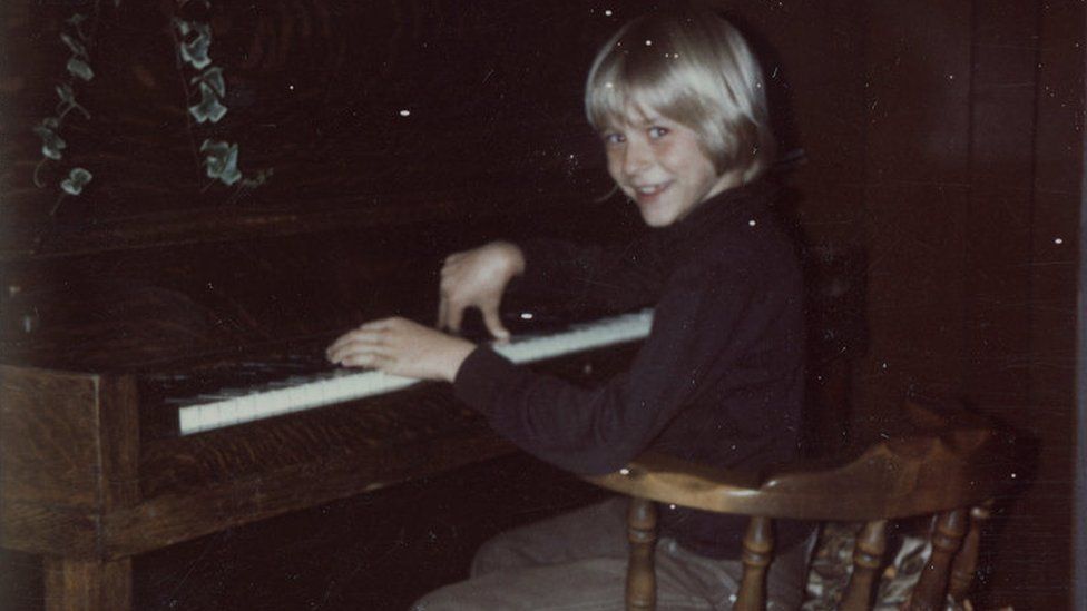 The collection includes this photo of Kurt, aged eight, playing the piano