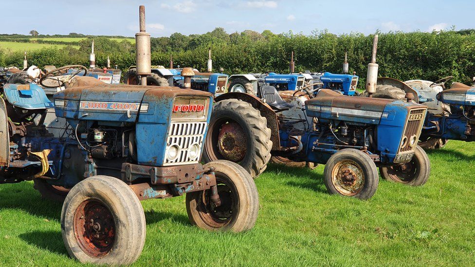 Tractors lined up in a field