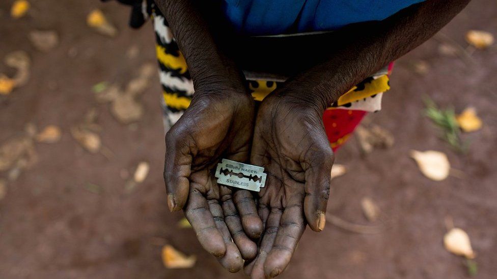 An FGM "cutter" in Kenya shows the razorblade she uses to cut girls' genitals