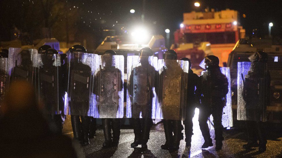 Police are seen during clashes with nationalist youths on the Springfield Road in west Belfast, in Northern Ireland