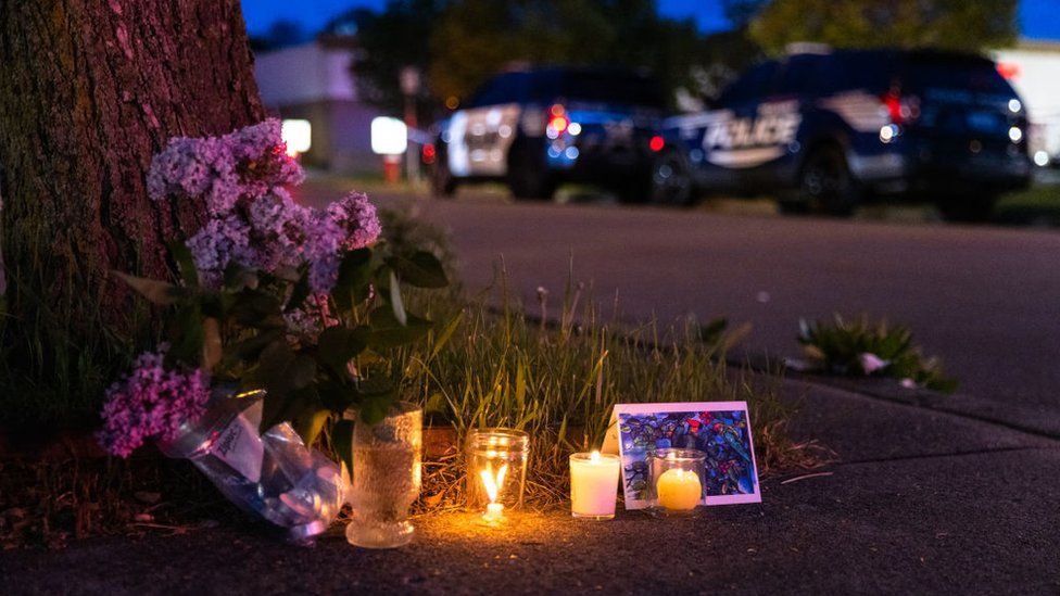 A small vigil across the street to the scene of a shooting at a Tops Friendly Market store in Buffalo, New York on 14 May