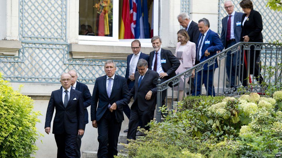 French Interior Minister Bernard Cazeneuve (left) walks with some of the European interior and transport ministers in Paris on 29 August 2015