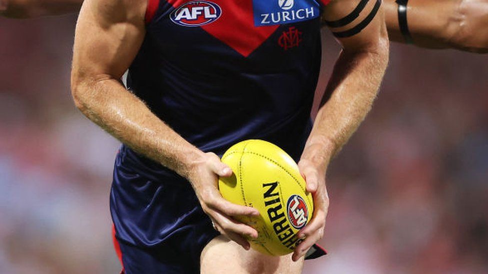A Demons player with the ball