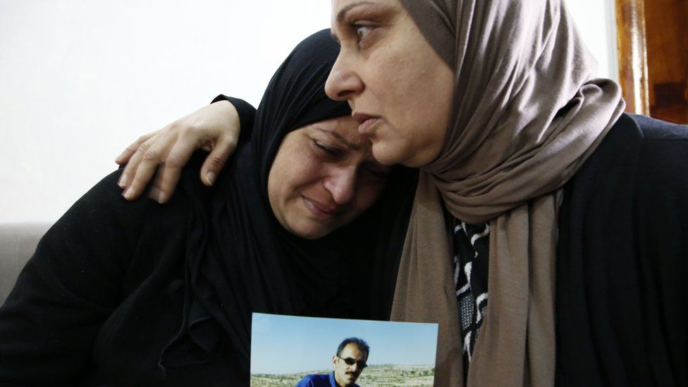 Relatives of Mahmoud Abu Asba mourn him at their home in the occupied West Bank village of Haloul (13 November 2018)