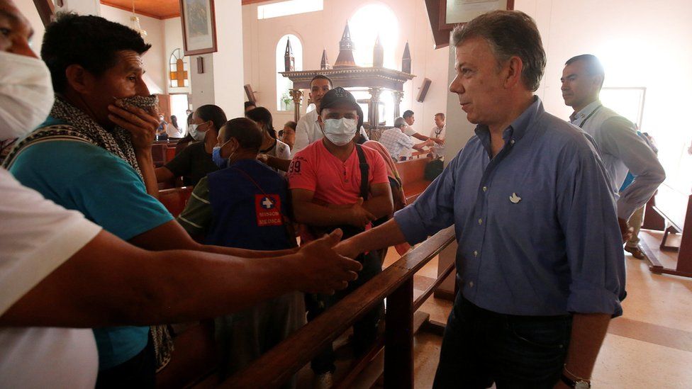 President Juan Manuel Santos, right, attends a mass for victims in Mocoa, Colombia April 4 2017