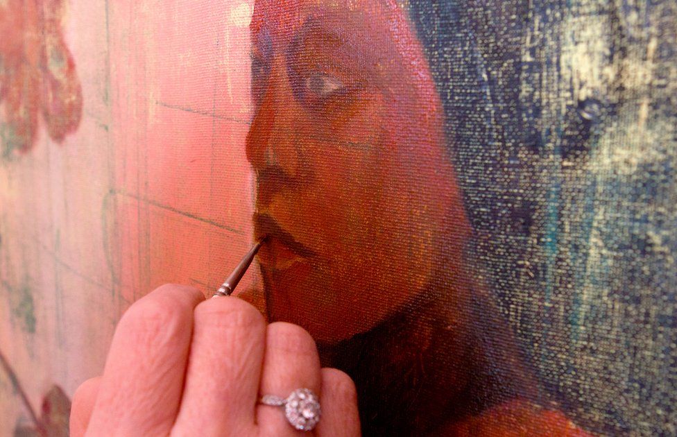 Geraldine works on one of her portraits