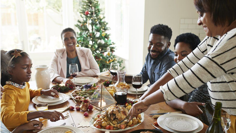 Family around dining table at Christmas