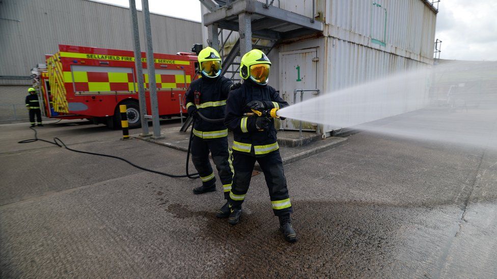 Firefighters use hose in training exercise