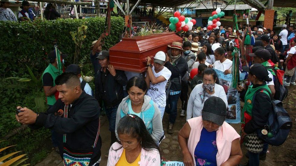 People carry the coffin of 14-year-old environmental activist Breiner David Cucuñame, who was killed in January