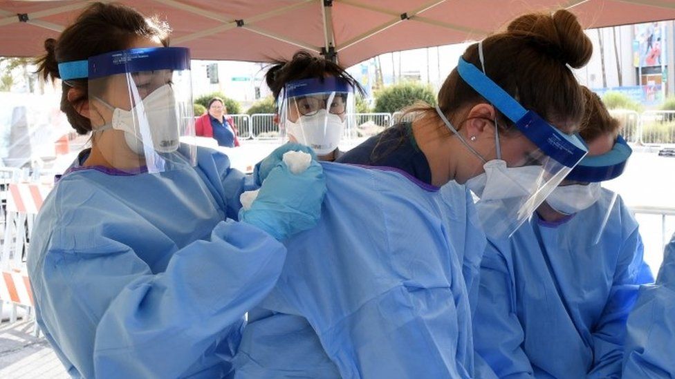 carers put on personal protective equipment