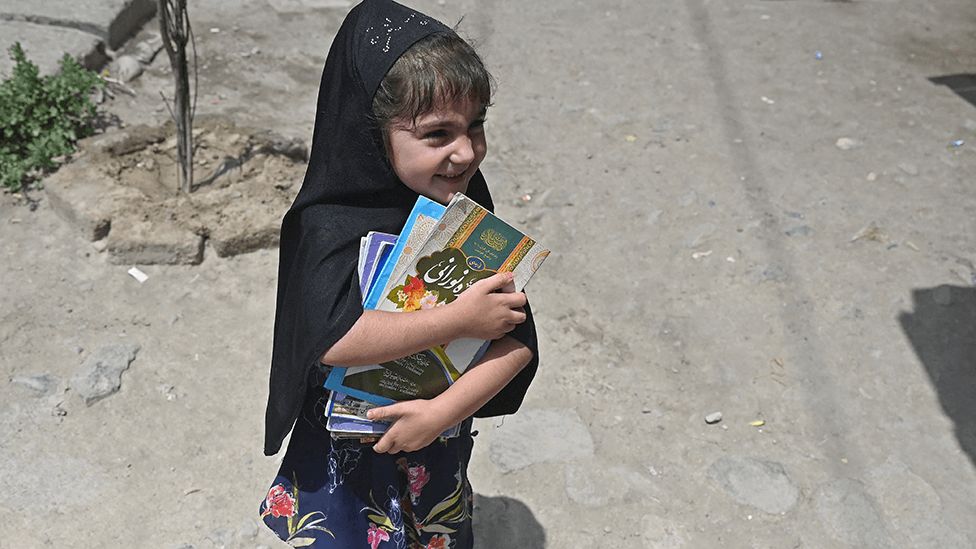Girl with books in Kabul on 12 July