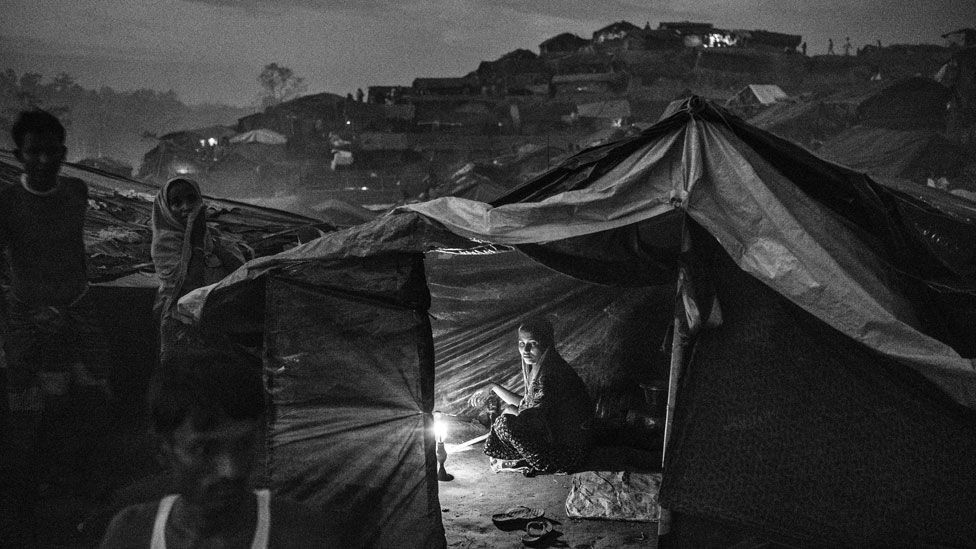 Rohingya woman sits in a tent in a refugee camp near Cox's Bazaar