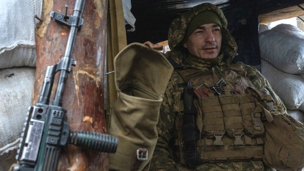 A Ukrainian soldier patrol the frontline in Zolote, Ukraine