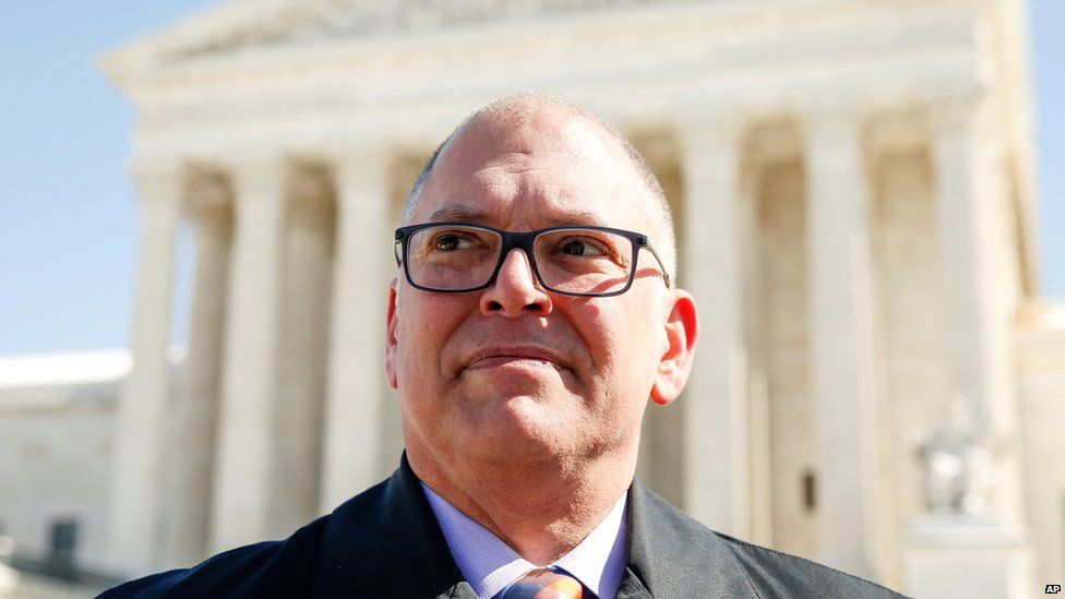 In this March 6, 2015, photo, Jim Obergefell speaks to a member of the media after joining the Human Rights Campaign as they deliver what they say are 207,551 copies of the “People’s Brief” that calls for full nationwide marriage equality, to the U.S. Supreme Court in Washington. Obergefell is the named plaintiff in Obergefell v. Hodges