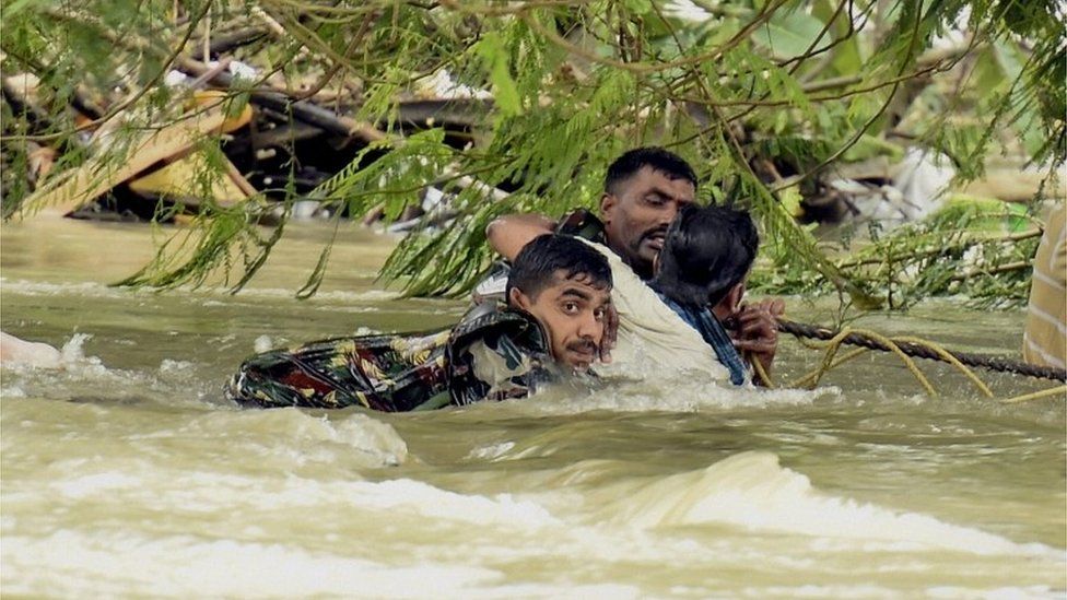Indian army soldiers rescue a man from flood waters in Chennai, India, Thursday, Dec. 3, 2015.