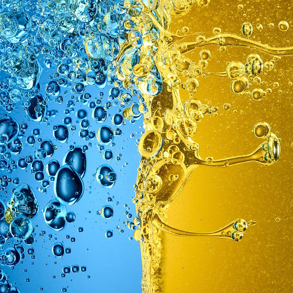 Close up image of oil and vinegar mixing together