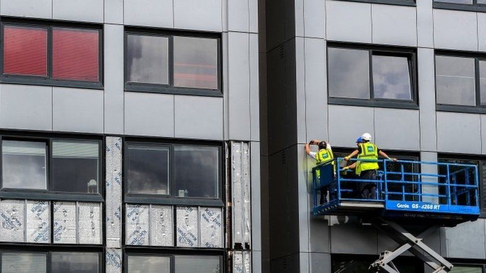Cladding being removed from a tower block in Manchester in 2017
