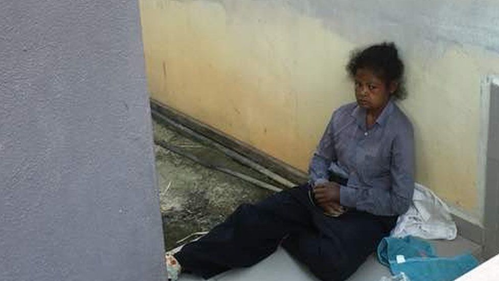 Adelina sat outside her employer's home in Malaysia