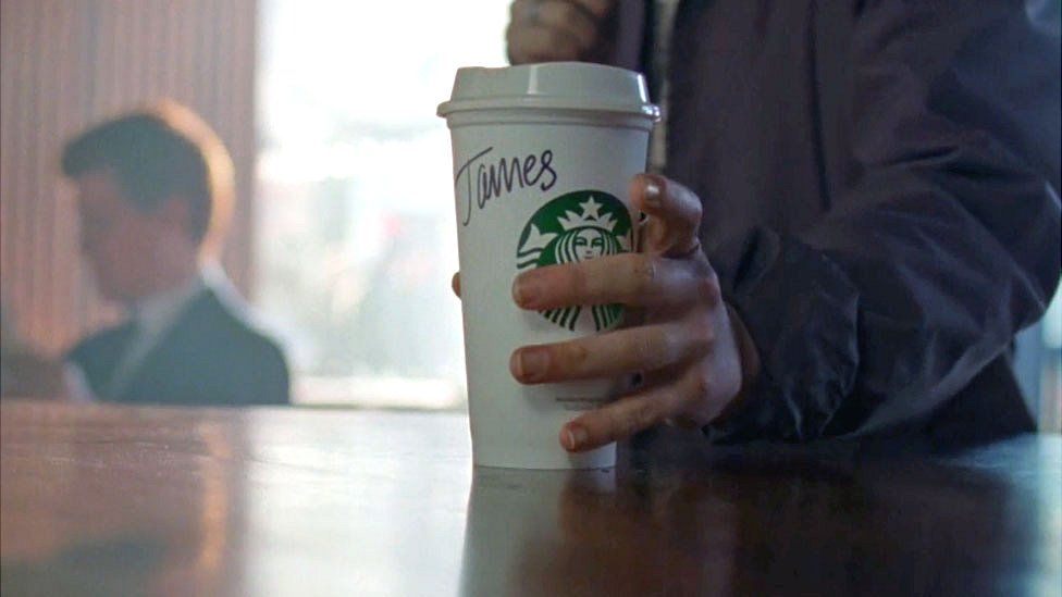 Starbucks customer holds coffee