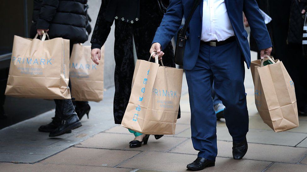 Customers leave Primark's flagship store on Oxford Street, London