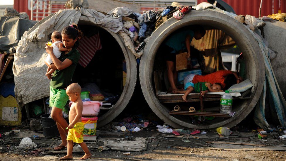 Families live in concrete pipes used as makeshift dwellings along a street in Manila on March 22, 2016. Roughly one quarter of the nation's 100 million people live in poverty, which is defined as surviving on about one US dollar a day, according to government data.