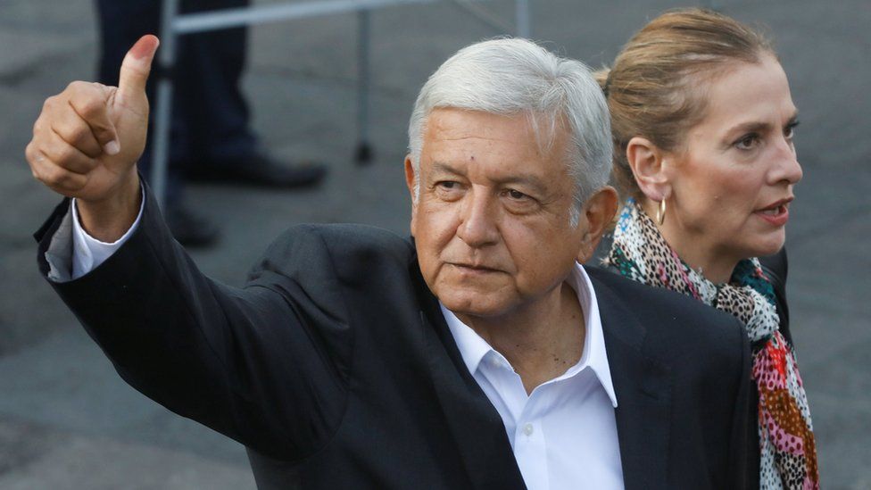 Presidential candidate Andres Manuel Lopez Obrador next to his wife Beatriz Gutierrez Muller gestures after casting his ballot at a polling station during the presidential election in Mexico City, Mexico July 1, 2018