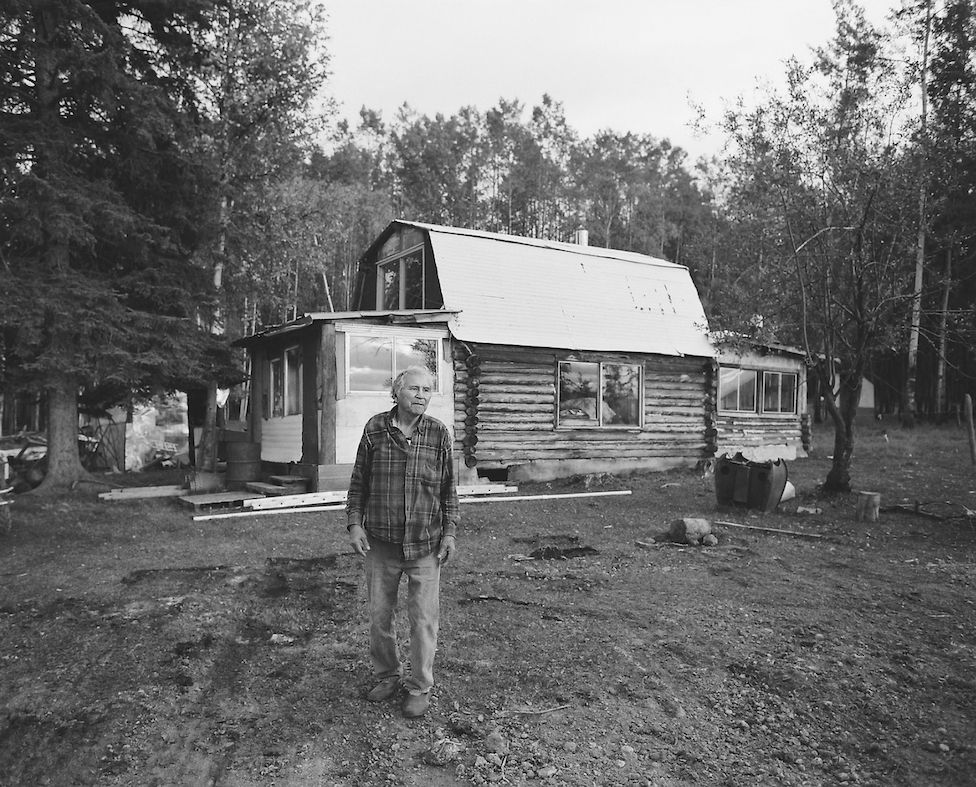 A resident in front of one of the cabins