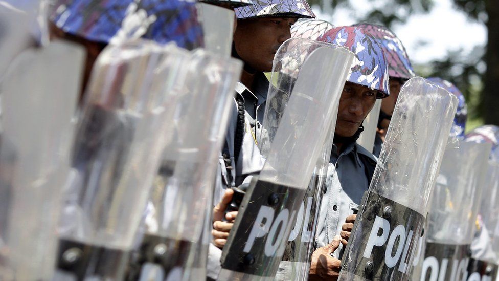 Riot police officer stand in line as they block the road to stop a protesters" march demanding labor rights in TetKone, near Naypyidaw, Myanmar, 18 May 2016.