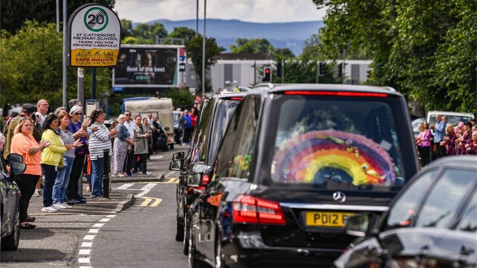 The funeral cortege passed St Catherine's Primary School, where the two boys were pupils