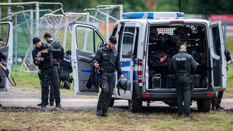 Armed police officers are seen during the ongoing manhunt for fugitive Yves Rausch