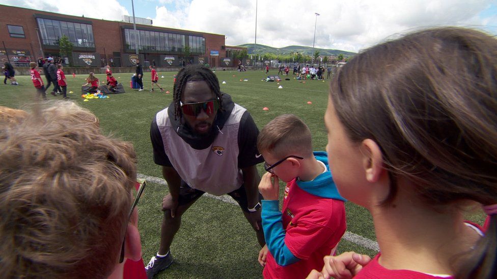 Devin Lloyd with children in Belfast