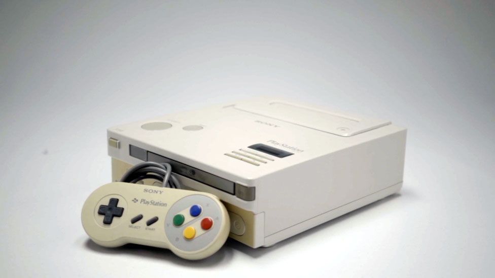 A general view of the Nintendo Playstation and its controller set against a white background